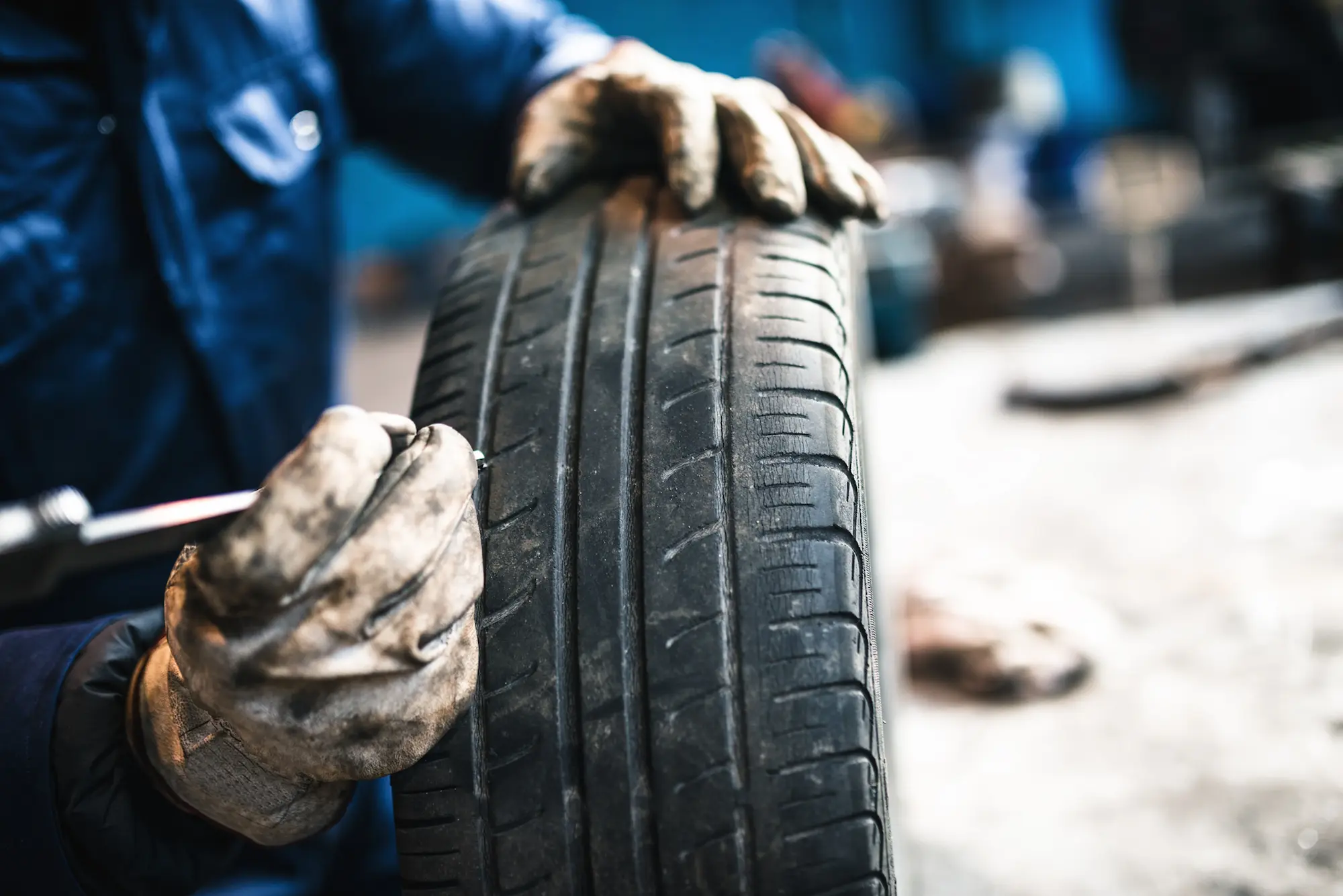 a man checking the condition of tyre
