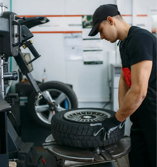 A man checking a flat tyre